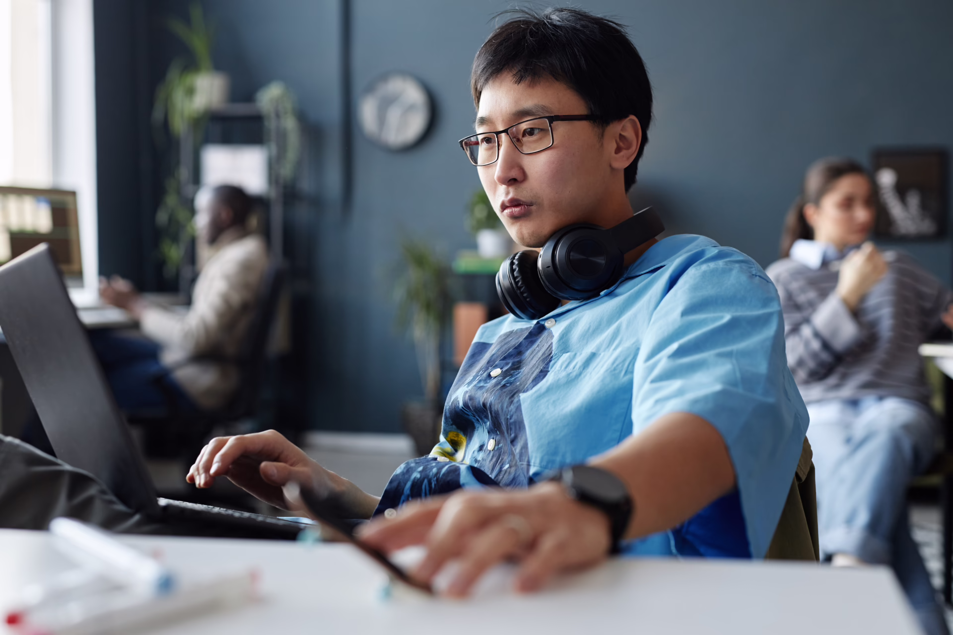 Professional web designer working on a custom business website in an Edmonton office environment - Webkind - Web Design Edmonton